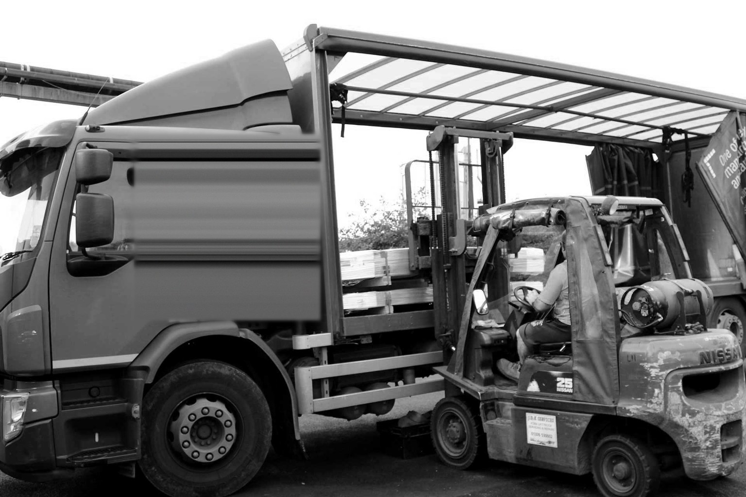 delivery truck being loaded by forklift